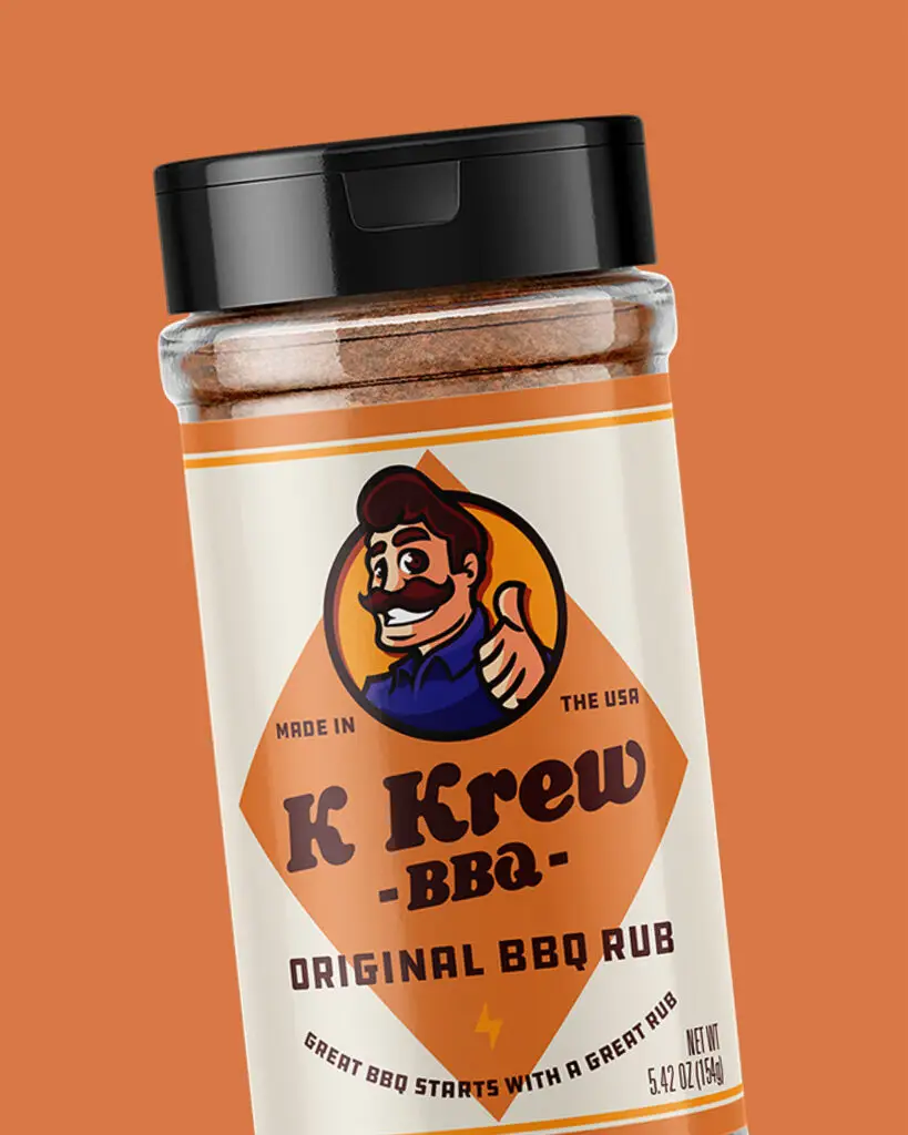 A 5.4oz shaker of K Krew BBQ's Original BBQ Rub, with brown and orange text and designs on a tan background.