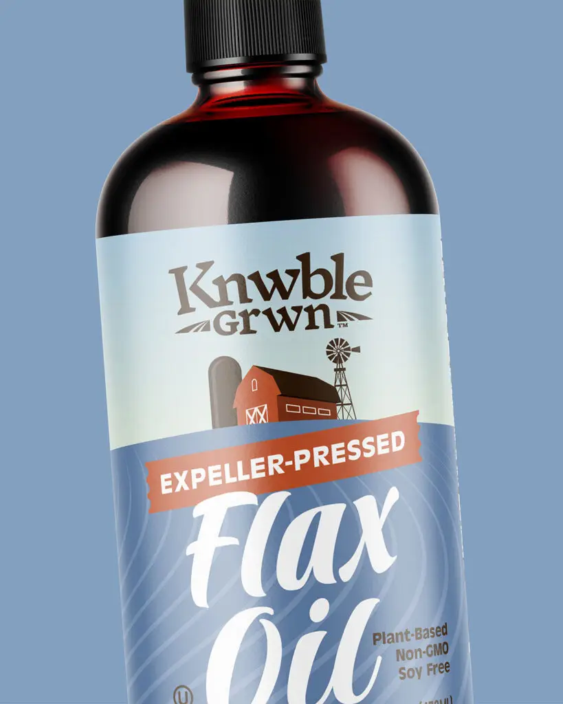 A bottle of Knwble Grwn Expeller-Pressed Flax Oil, with white text and a picture of a farm against a blue background.