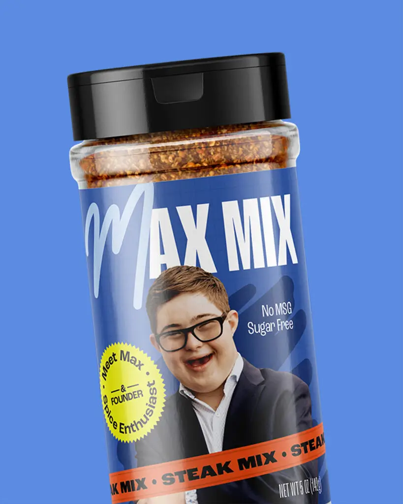 A shaker of Max Mix's Steak Mix, featuring a picture of company founder Max and white text on a dark blue background.