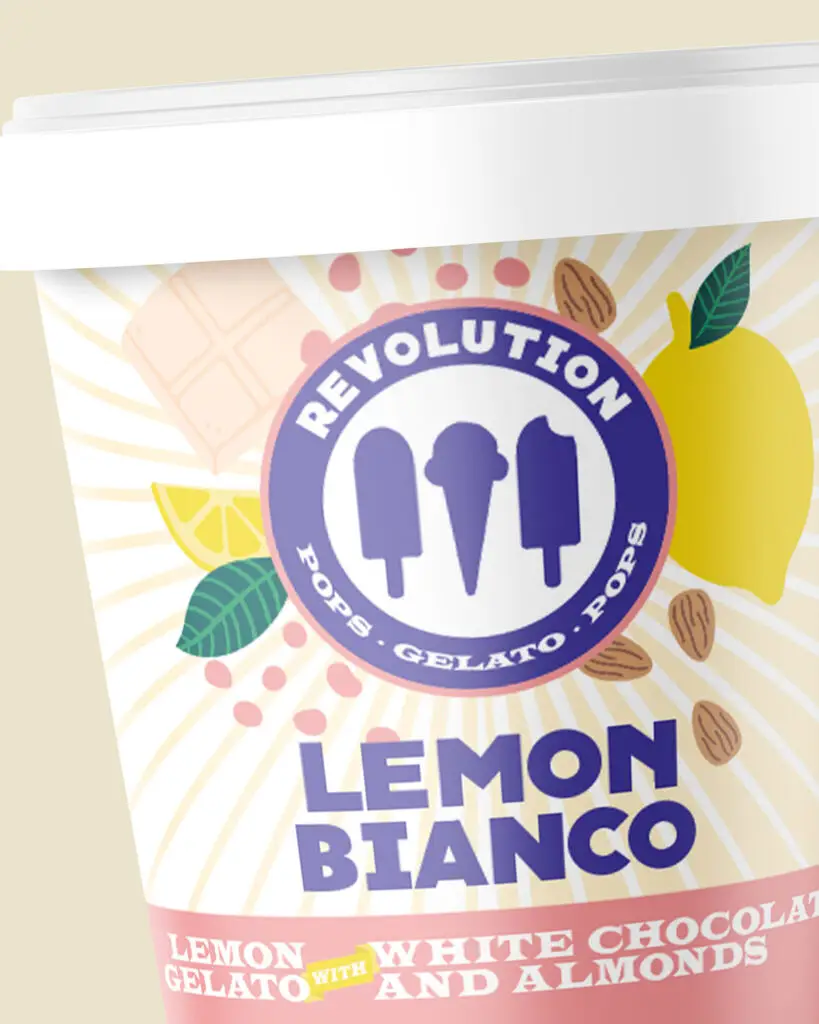 A carton of Revolution Artisan Pops and Gelato, Lemon Bianco flavor, with purple text and the company logo on a yellow, white, and pink background.